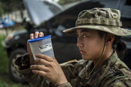 Army Spc. Livia Barnett examines mosquitos during Continuing Promise, a humanitarian assistance and goodwill mission, in San Pedro Sula, Honduras, Nov. 3, 2022.