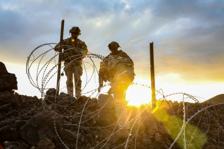 Soldiers set up obstacles as defense against a possible attack by opposing forces during a training exercise at Pohakuloa Training Area, Hawaii, Nov. 3, 2022.