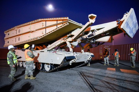 Soldiers from the 16th Sustainment Brigade assigned to the 260th Movement Control Team scan military vehicles during the transport, offload, and processing of over 1,250 equipment items assigned to the 2nd Armored Brigade Combat Team, 1st Infantry Division, at the port of Vlissingen, Netherlands, on January 10, 2023. 

Once a vehicle gets offloaded from the ship, Soldiers from the 260th MCT use a Distributional Retrograde Adaptive Planning and Execution Management or DRAM tablet to scan the military shipping labels on these vehicles. Doing this will ensure that they know all the information relating to the vehicle, and then they can ensure that it gets on the correct truck, barge, or train so it can get to the final location in Europe.