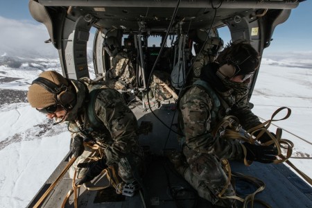 U.S. Army Jumpmaster Qualified Paratroopers assigned to the 19th Special Forces Group (Airborne), pull in the static lines in a UH-60 Black Hawk Helicopter after a successful exit of 6 paratroopers on January 21, 2023 near Camp Williams, Utah. Jumpmasters are expert paratroopers who train, teach and ensure airborne operations are conducted in a safe manner.