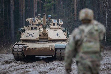 A U.S. Soldier assigned to 1st Battalion, 9th Cavalry Regiment, 2nd Armored Brigade Combat Team, 1st Cavalry Division, directs a M1A2 tank crew into the waiting queue during a live-fire exercise at Bemowo Piskie, Poland, Feb. 16, 2023. The 4 ID and their supporting units are proudly working alongside NATO allies and regional security partners to provide combat-credible forces to V Corps, America’s forward deployed corps in Europe.