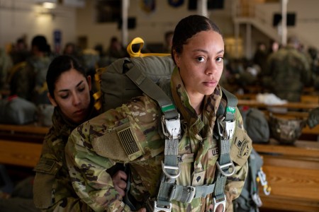 U.S. Army Spc. Destiny Clark and Spc. Kennia Lopez, both paratroopers assigned to the 4th Quartermaster Company, 725th Brigade Support Battalion (Airborne), 2nd Infantry Brigade Combat Team (Airborne), 11th Airborne Division, don parachutes ahead of an all-women jump at Joint Base Elmendorf-Richardon, Alaska, March 7, 2023. The airborne operation was held in recognition of Women’s History Month, and marked the first all-female jump in division history. Every battalion in the 2/11 was represented in the jump, as well as members of Division staff.  