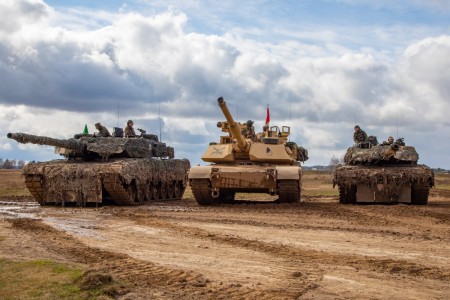 U.S. Soldiers assigned to the 2nd Armored Brigade Combat Team, 1st Cavalry Division, NATO eFP Battle Group Poland, supporting the 4th Infantry Division, position an M1A2 Abrams tank between German Leopard 2A6 tanks during a combined live fire exercise at Bemowo Piskie, Poland, April 4, 2023. The 4th Inf. Div.’s mission in Europe is to engage in multinational training and exercises across the continent, working alongside NATO allies and regional security partners to provide combat-credible forces to V Corps, America’s forward deployed corps in Europe.
