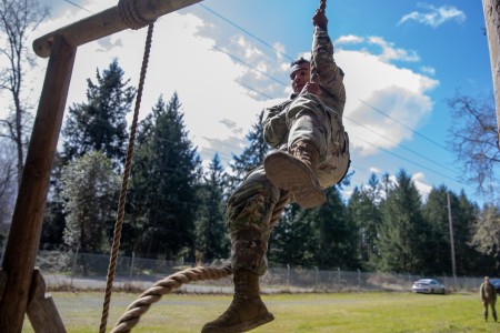 U.S. Army Spc. Christian Jaen Morales with the 259th Expeditionary Military Intelligence Brigade, headquartered on Joint Base Lewis-McChord, Washington, climbs rope during the obstacle course for a Military Intelligence Readiness Command Non-Commissioned Officer of the Year and Soldier of the Year Competition on Joint Base Lewis-McChord, Washington, April 4, 2023. The competition aims to test fundamental Soldier skills, promote esprit de corps throughout the Army, and recognize those Soldiers who have separated themselves from their peers throughout the competition.