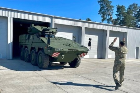 A soldier from Lithuania&#39;s Uhlan Battalion guides a Vilkas infantry fighting vehicle during a visit by Pennsylvania National Guard Soldiers from 1st Squadron, 104th Cavalry Regiment, 2nd Infantry Brigade Combat Team, May 4, 2023, in Alytus, Lithuania.
