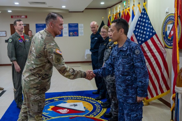 Gen. Charles Flynn, commanding general of U.S. Army Pacific, left, presents his challenge coin to Japanese Maritime Self-Defense Force Cmdr. Yoichi Kabasawa and naval officers from the United Kingdom, New Zealand, and Australia during his tour of Commander, Logistics Group, Western Pacific/Task Force 73. 
Flynn stressed the importance of Land Forces during the 2023 Land Forces Pacific Symposium or LANPAC in May 2023.
COMLOG WESTPAC supports deployed surface units and aircraft carriers, along with regional Allies and partners, to facilitate patrols in the South China Sea, participation in naval exercises and responses to natural disasters.